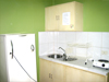 The studio-unit is complete with refrigerator, cupboard, stove and kitchen sink.